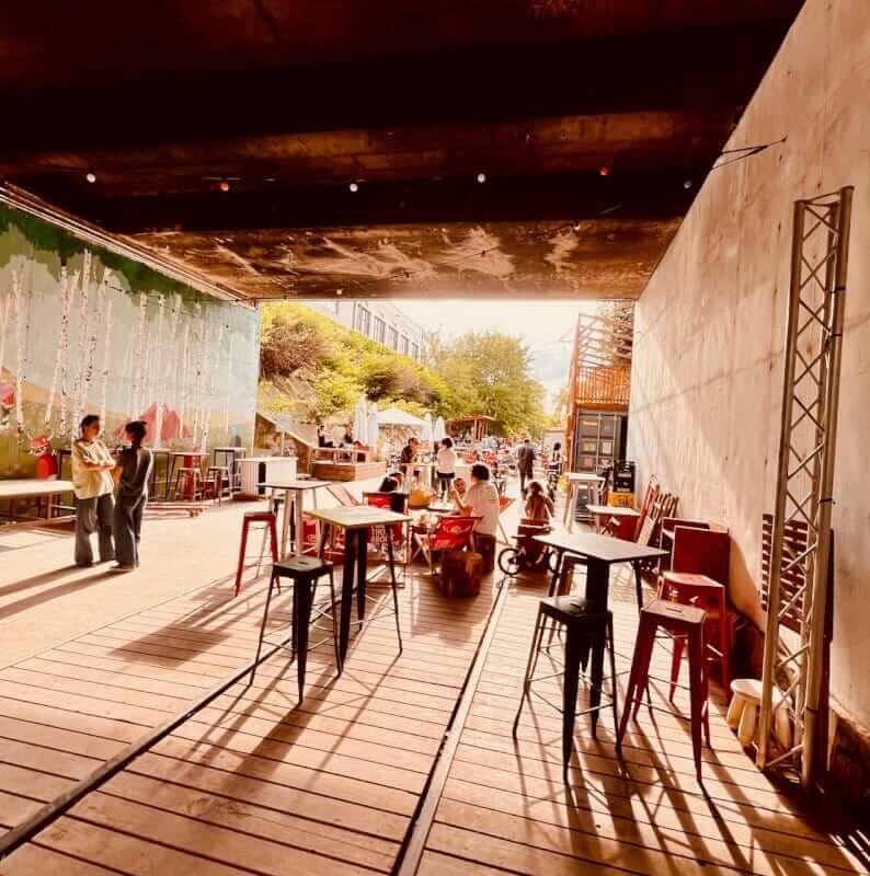 Jardin des Traverses: Paris's Hidden Railway Garden Near Adidas Arena 3 Covered terrace under the bridge — Jardin des Traverses Petite Ceinture Paris 18